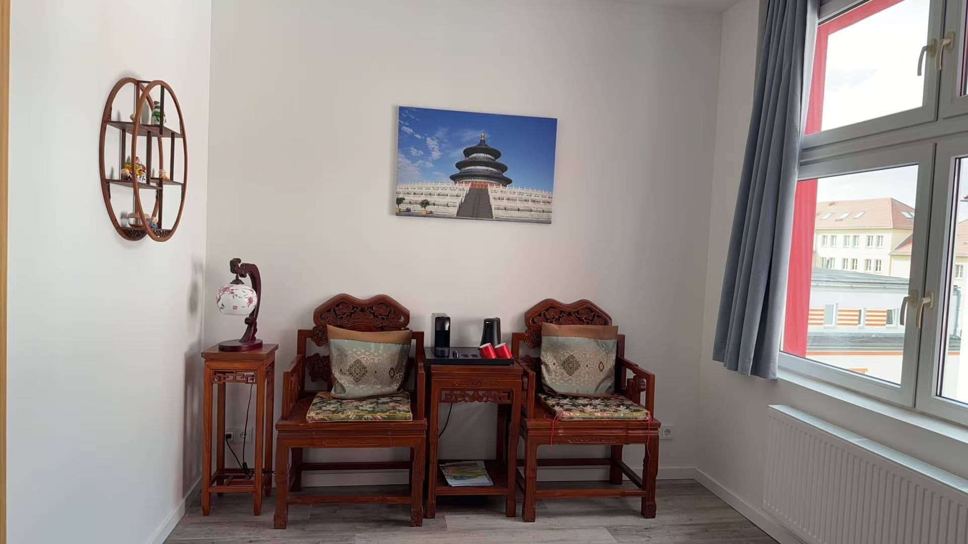 两张雕花座椅、丝绸靠垫与茶水台